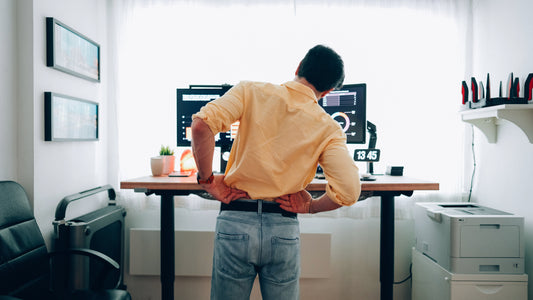 Lower back in pain while standing at a dual-monitor standing desk on hard floor without an anti-fatigue mat