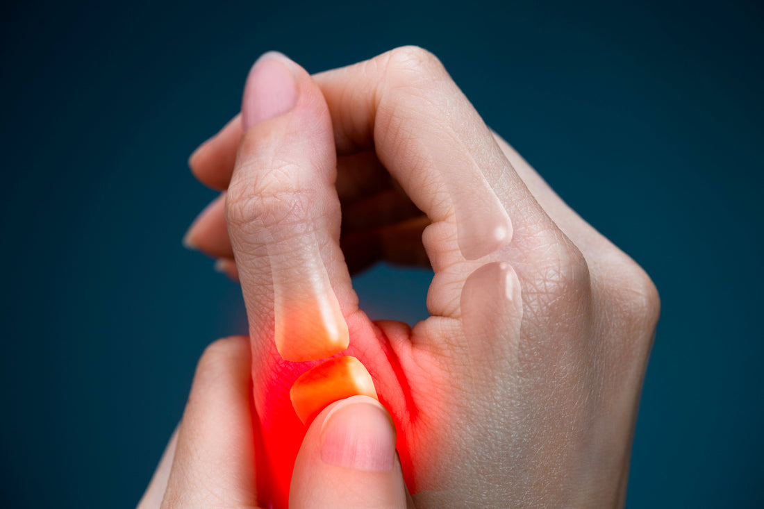 Close-up of hands with red glowing inflammation highlight on thumb joint showing pain from trigger thumb, De Quervain's tenosynovitis, or CMC arthritis