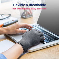 Compression glove worn while typing on laptop, showing flexible fingertip-free design for daily office use.