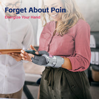 Woman smiling while using phone with arthritis glove and wrist brace, conveying pain-free confidence.