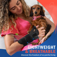 Woman holding a dachshund dog while wearing FEATOL lightweight and breathable wrist thumb brace, demonstrating comfortable pain-free daily activities at home