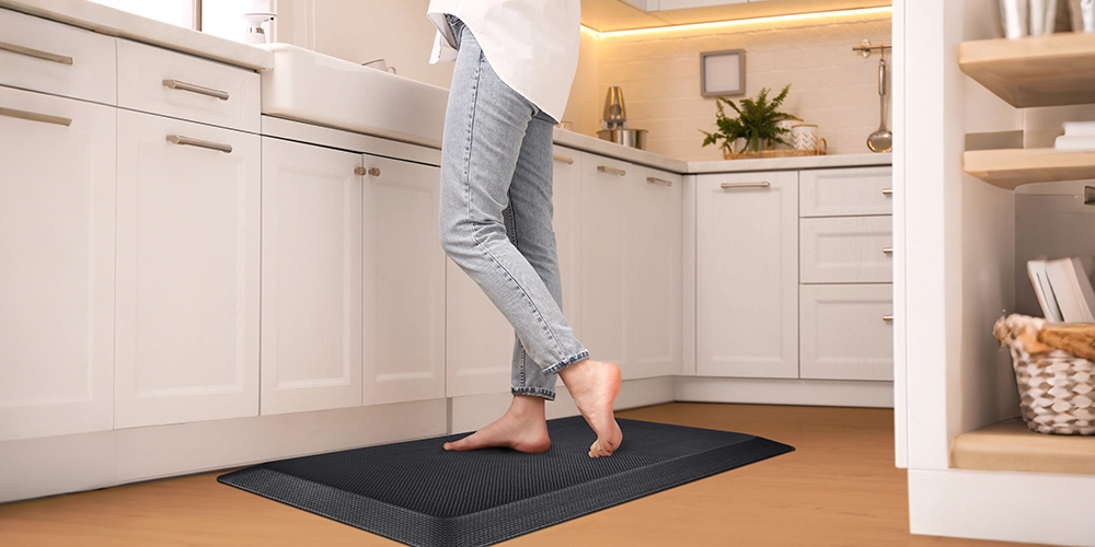woman standing on FEATOL kitchen anti fatigue floor mat for long cooking sessions